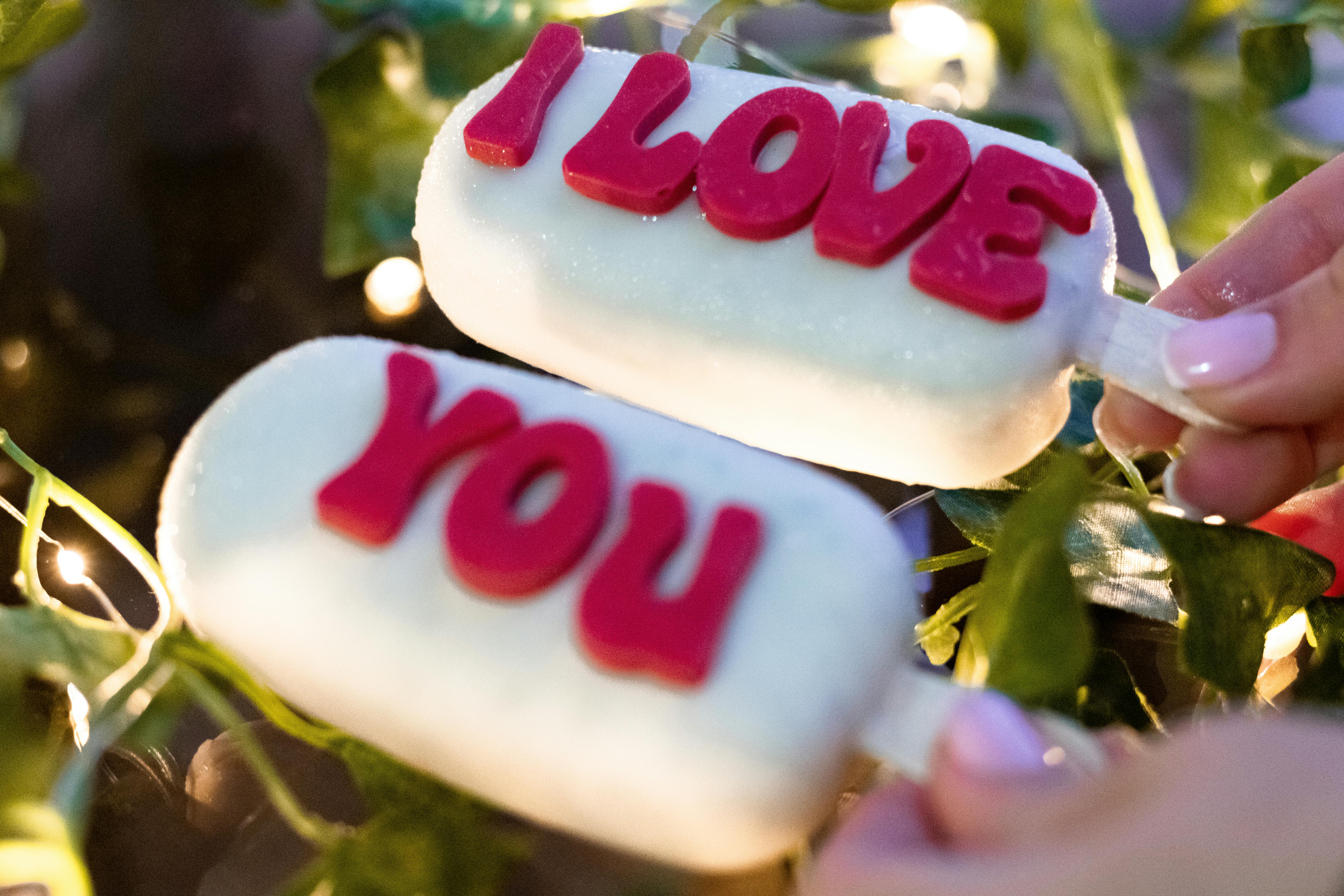 person holding ice pops with text