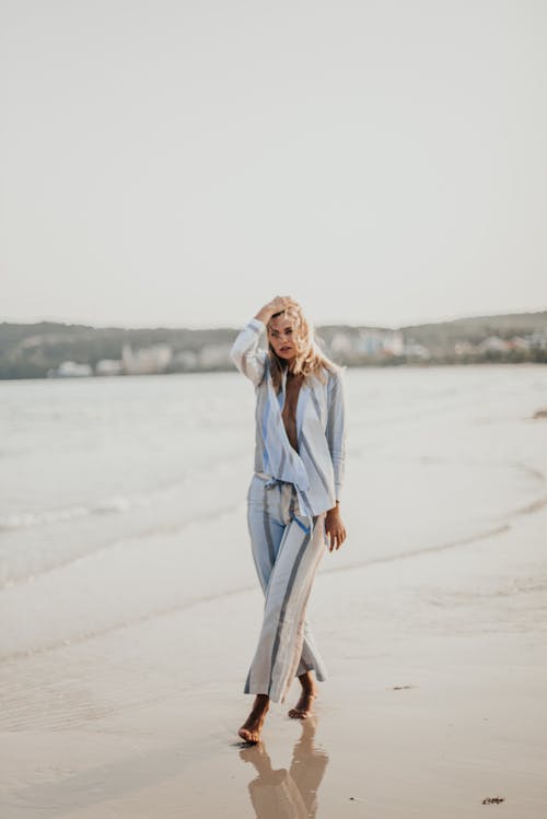 A Woman in a Stylish Outfit Walking by the Beach