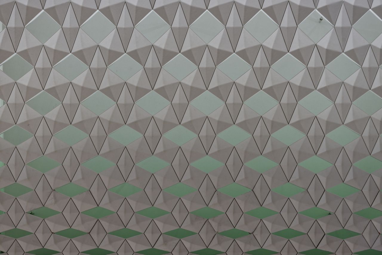 seamless geometric pattern featuring diamond shapes in a soft color gr
