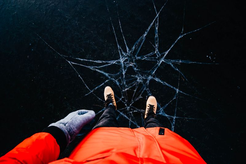 Person in winter clothing on cracked ice