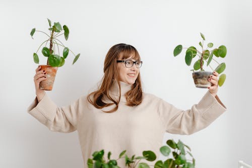 Free Woman Enjoying Seedlings of Missionary Plant Stock Photo