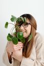 Woman in Gray Long Sleeved Shirt Holding Green Round Fruit