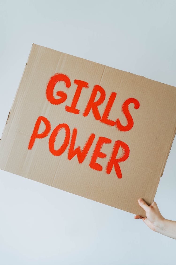 A Cardboard Sign That Says Girls Power