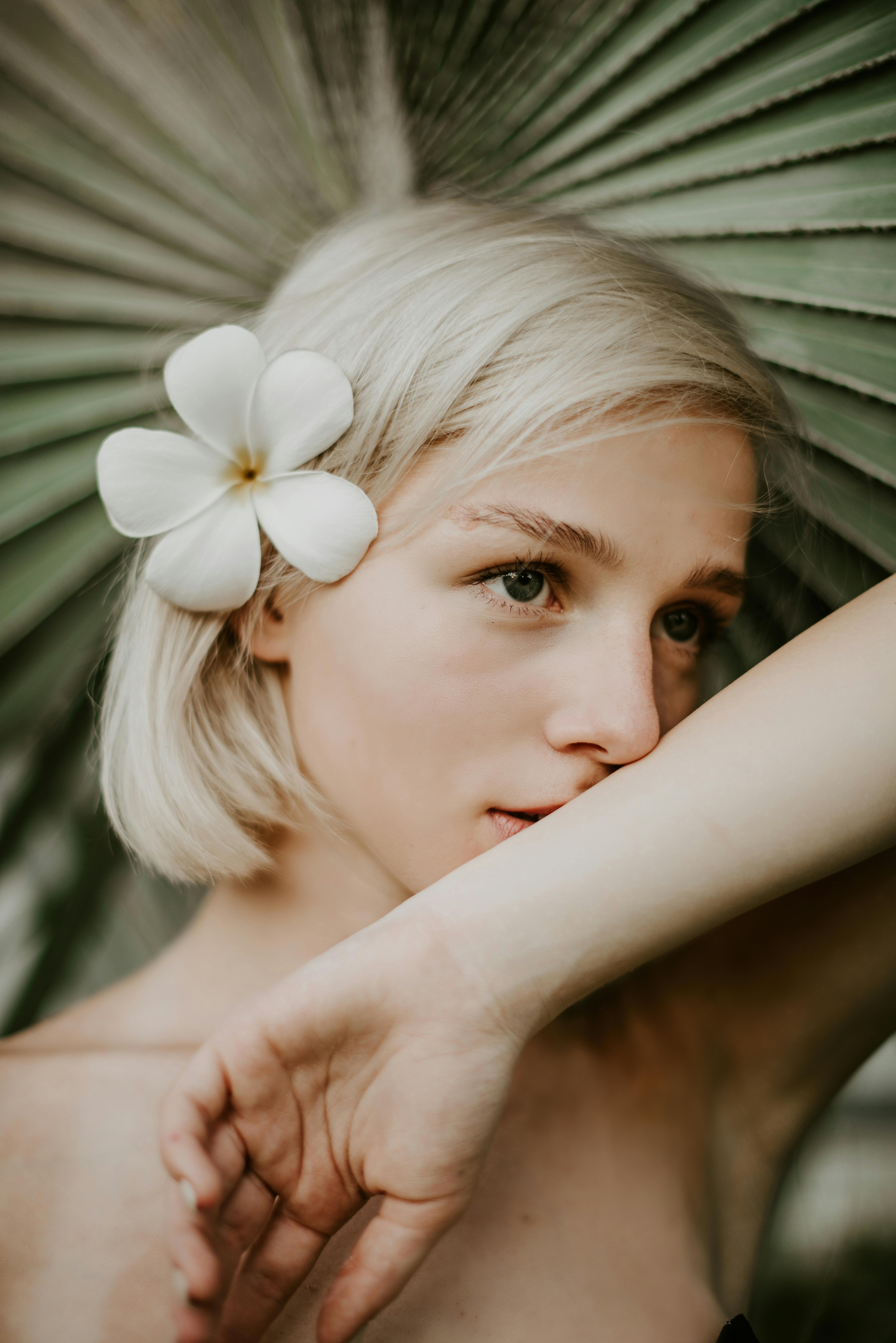 a woman with a flower on her ear