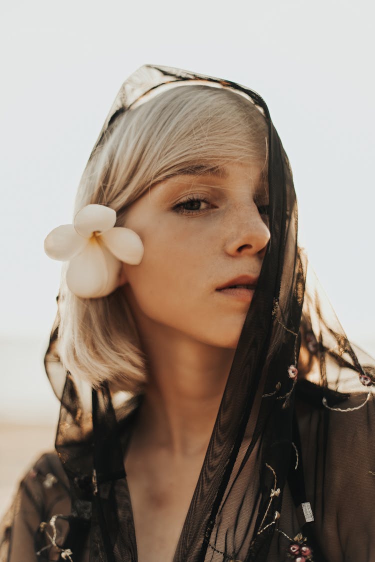 A Woman With Black Veil Covering Half Her Face