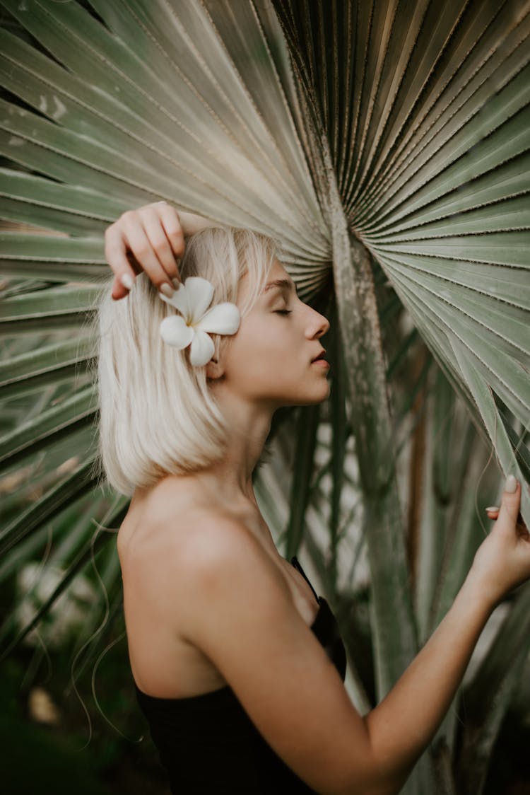 A Woman With A Flower On Her Ear