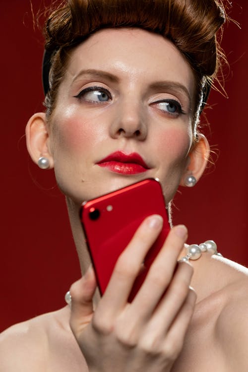 Free Woman Holding Red Smartphone Stock Photo