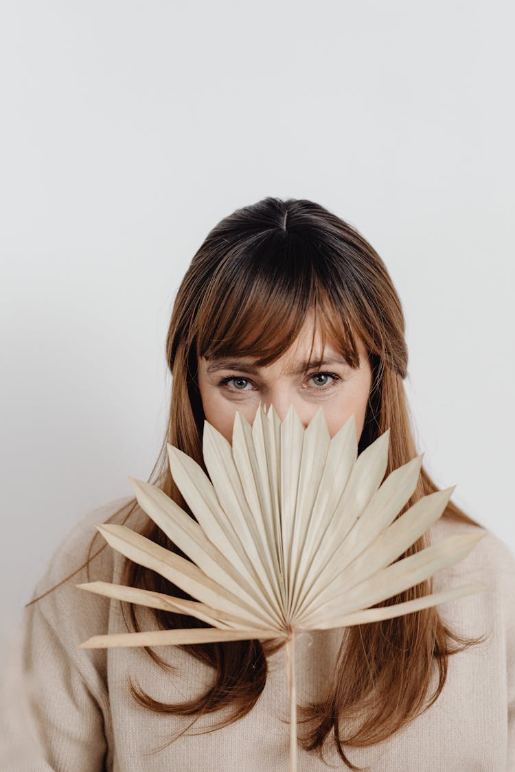 Woman With Leaf Over Face