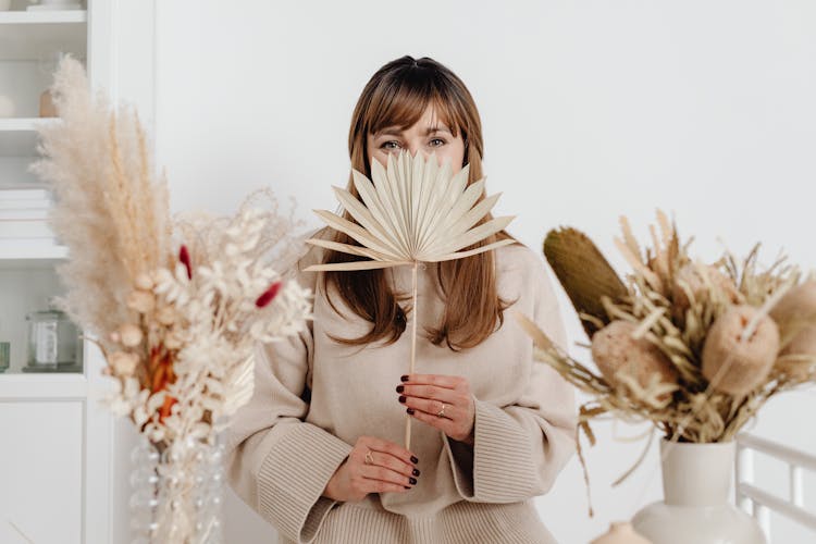 Woman Hiding Behind Paper Fan