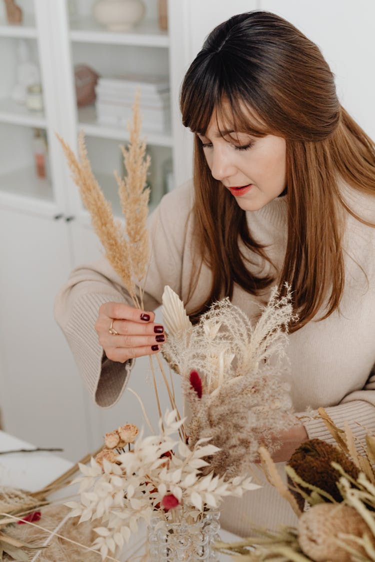 Woman Making A Autumnal Flower Composition 