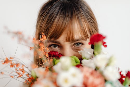 Woman Covering Her Face with Flowers