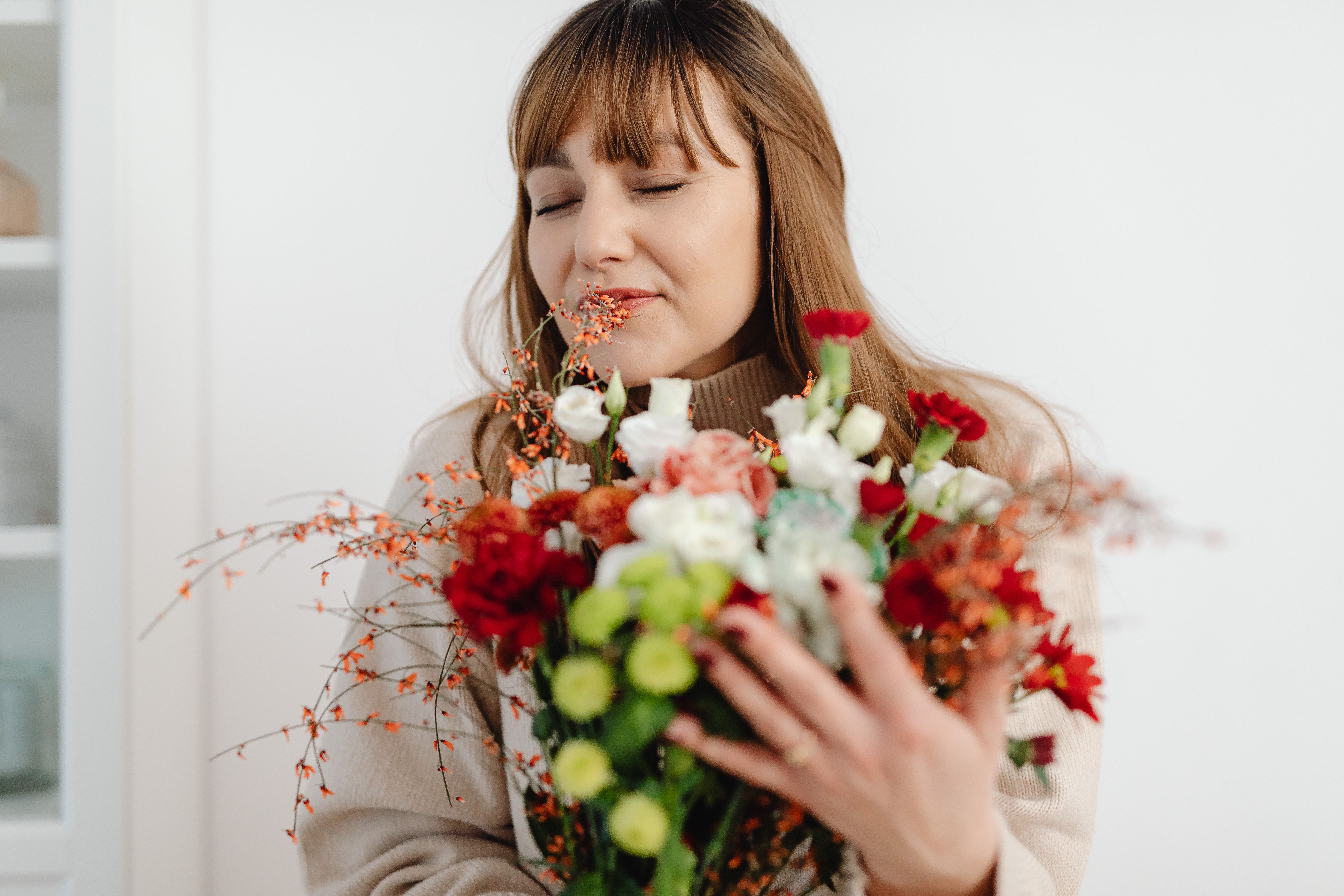 Woman Holding a Bouquet of Flowers · Free Stock Photo