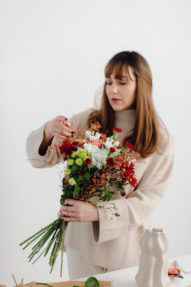 Florist Making Flowers Bouquet In Studio