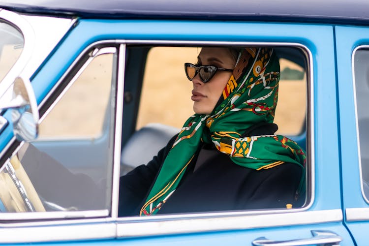 Charming Woman Driving Retro Car In Daytime