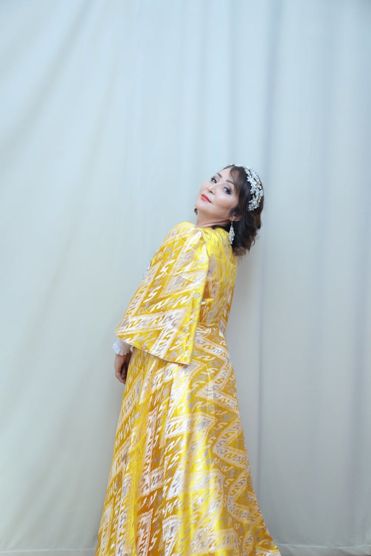 Mature Woman Posing In A Long Yellow Dress