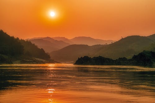 Free Sunset Over the Mountain Range Near the River Stock Photo