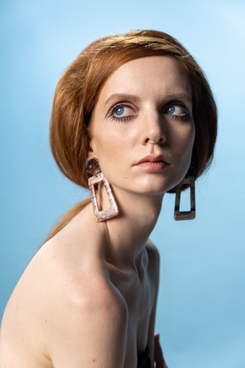 A Woman with Brown Hair and Wearing Earrings