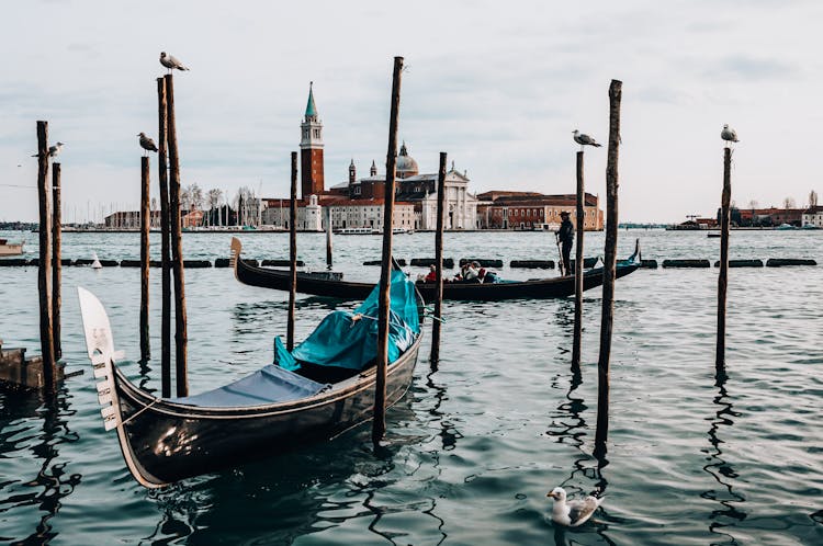 Boat Docked Beside A Wooden Posts