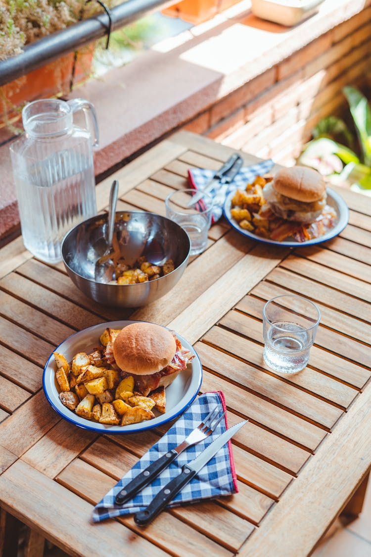 Delicious Burgers With Potato On Table