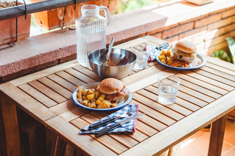 Appetizing Burgers And Potato Wedges On Table