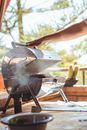 Crop person cooking meat on grill