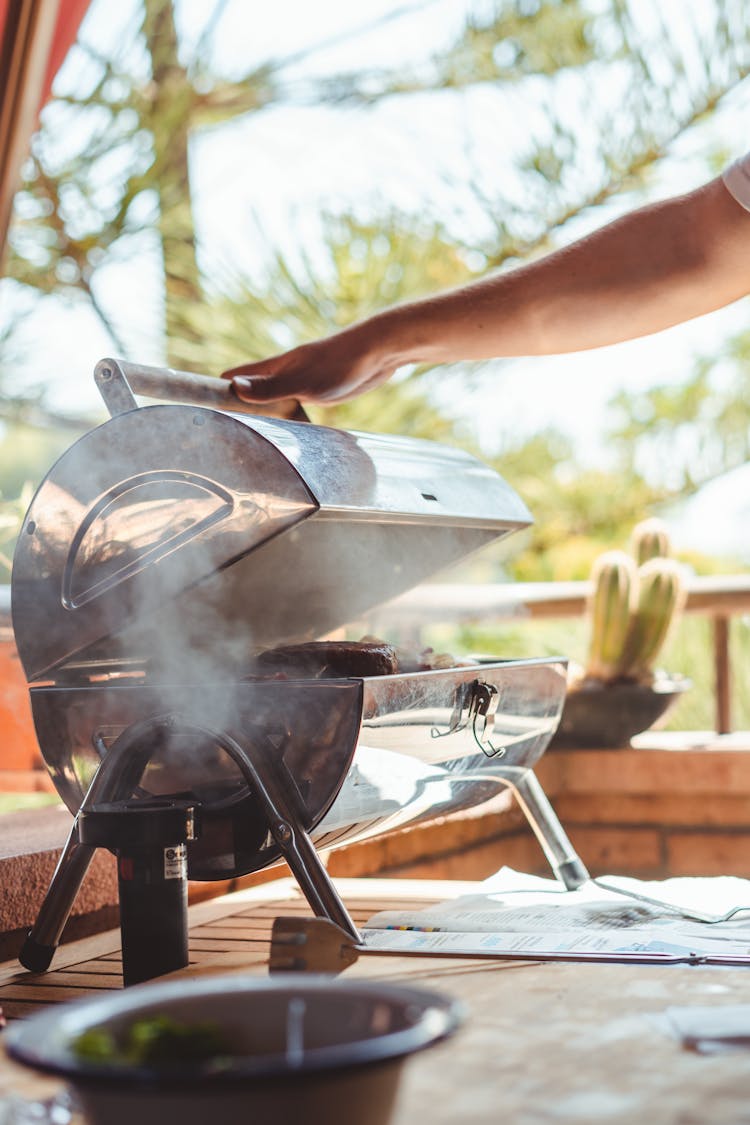 Crop Person Cooking Meat On Grill