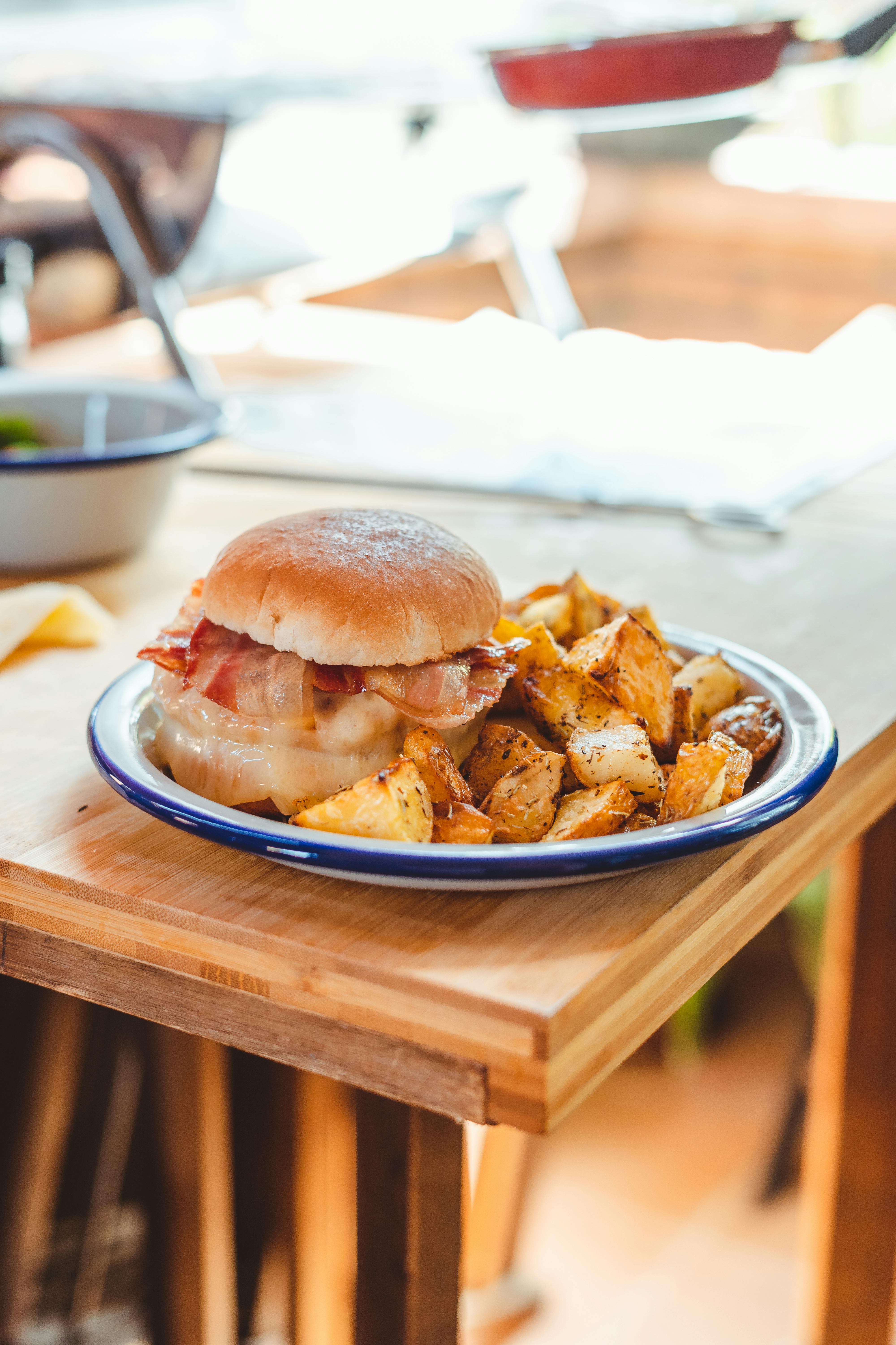 tasty burger with bacon and potatoes