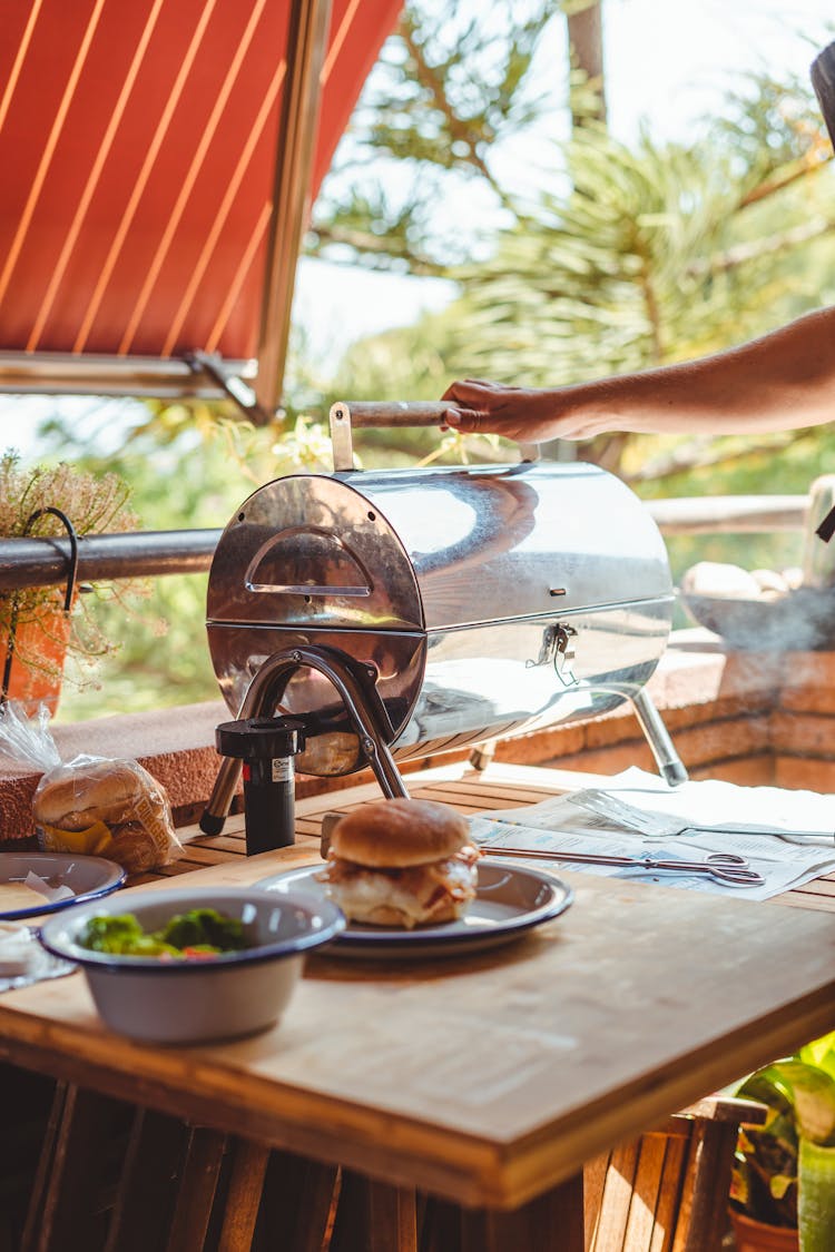 Crop Person Using Grill While Cooking