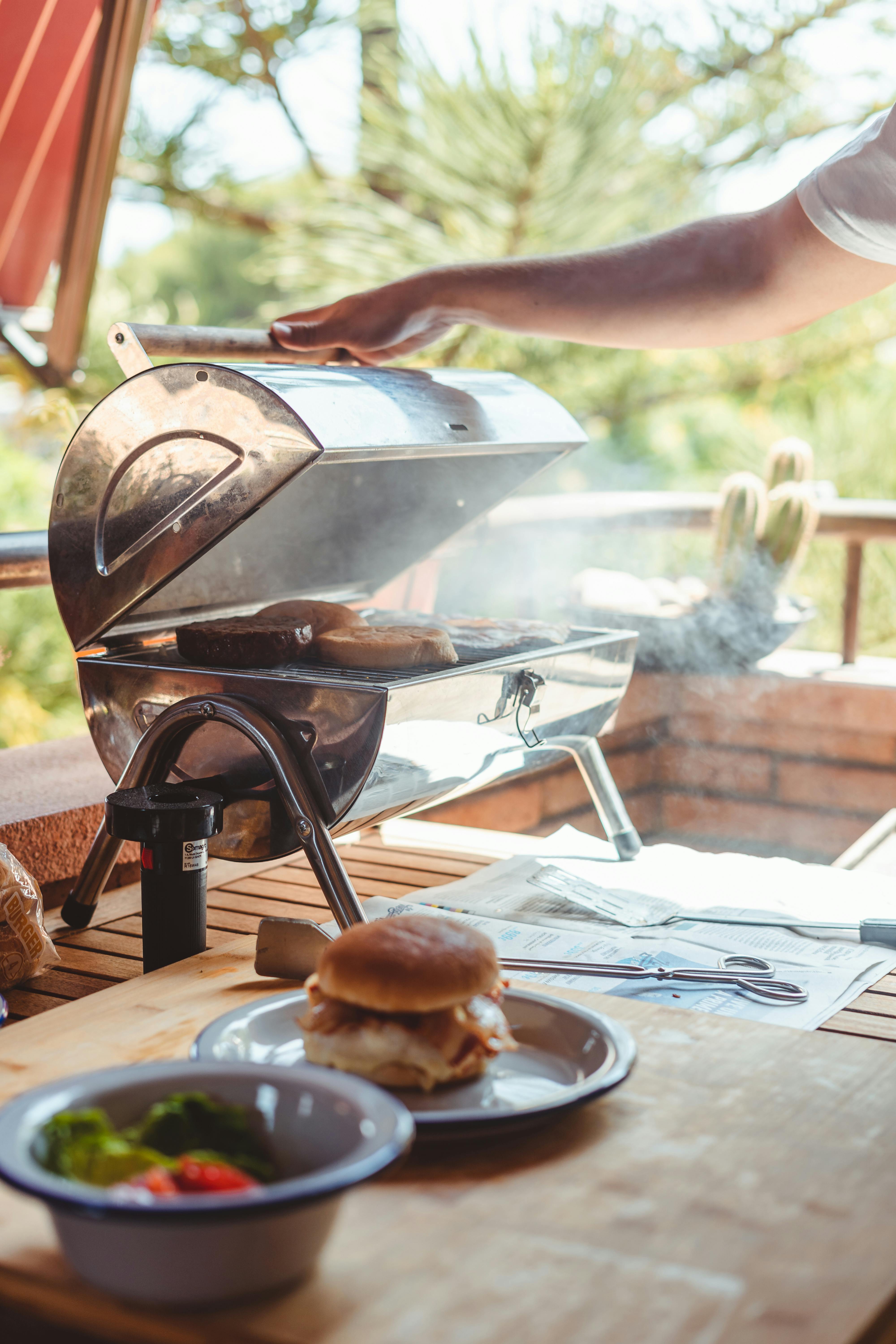 man opening grill with fried slices of bun