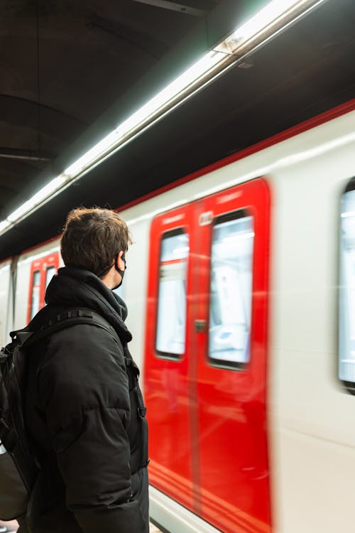 Anonymous man standing on subway station near train