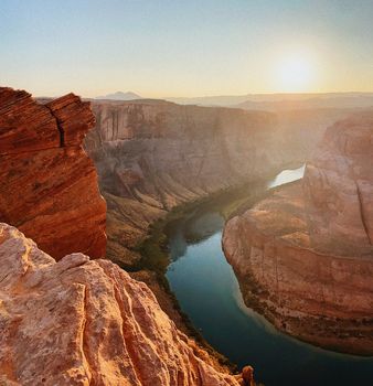 A breathtaking sunset view of Horseshoe Bend with the Colorado River winding through the canyon.