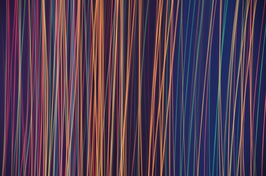 An abstract image featuring dynamic colorful light stripes creating a vibrant pattern.