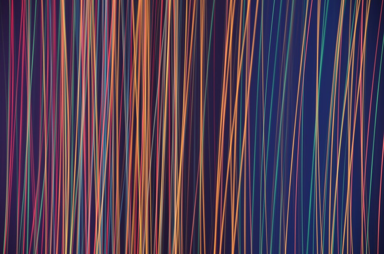 an abstract image featuring dynamic colorful light stripes creating a