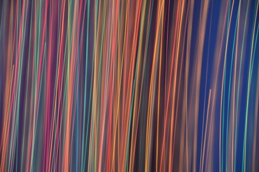Colorful abstract pattern of neon light trails creating an energetic and dynamic background.