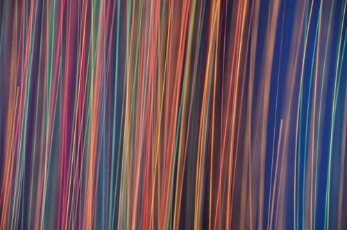 Free Colorful abstract pattern of neon light trails creating an energetic and dynamic background. Stock Photo