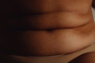 Person Wearing Brown Shirt Showing Her Breast
