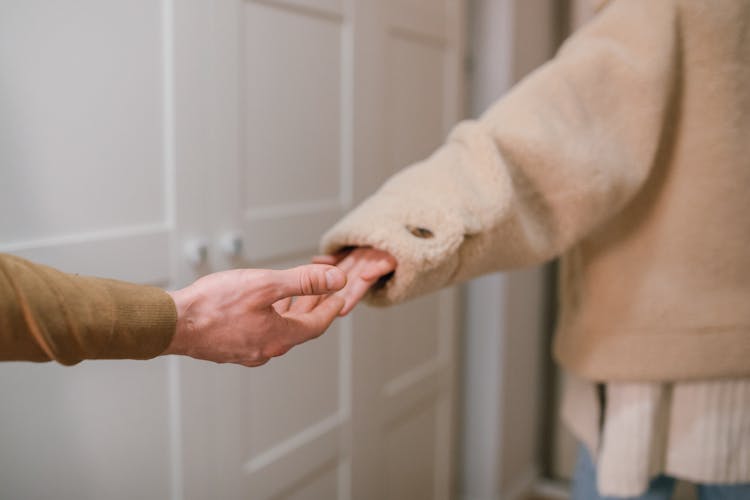 A Couple's Hands Breaking Apart