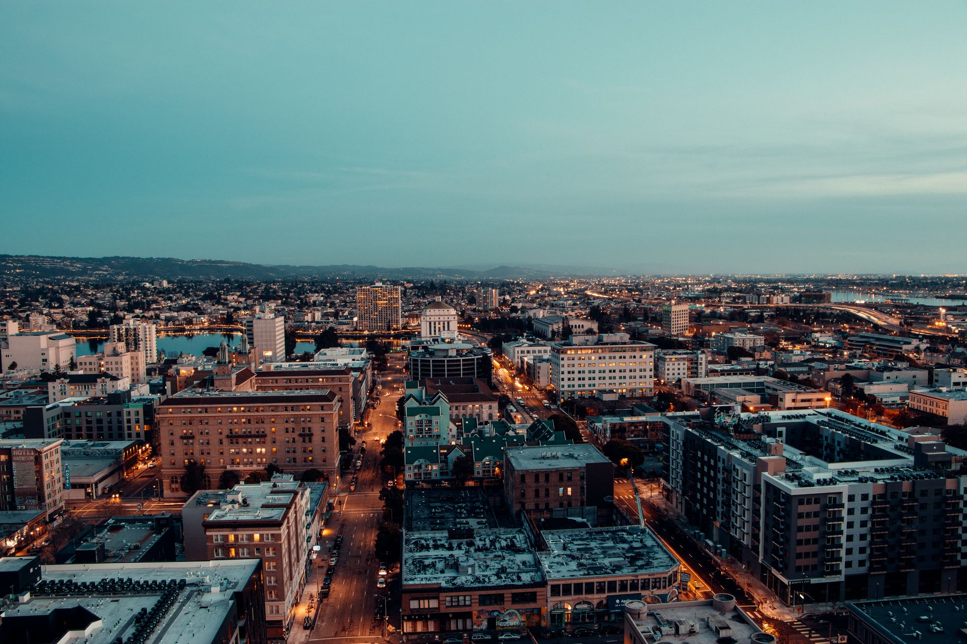 Breathtaking aerial view of a vibrant cityscape at evening dusk, highlighting urban architecture under a twilight sky.