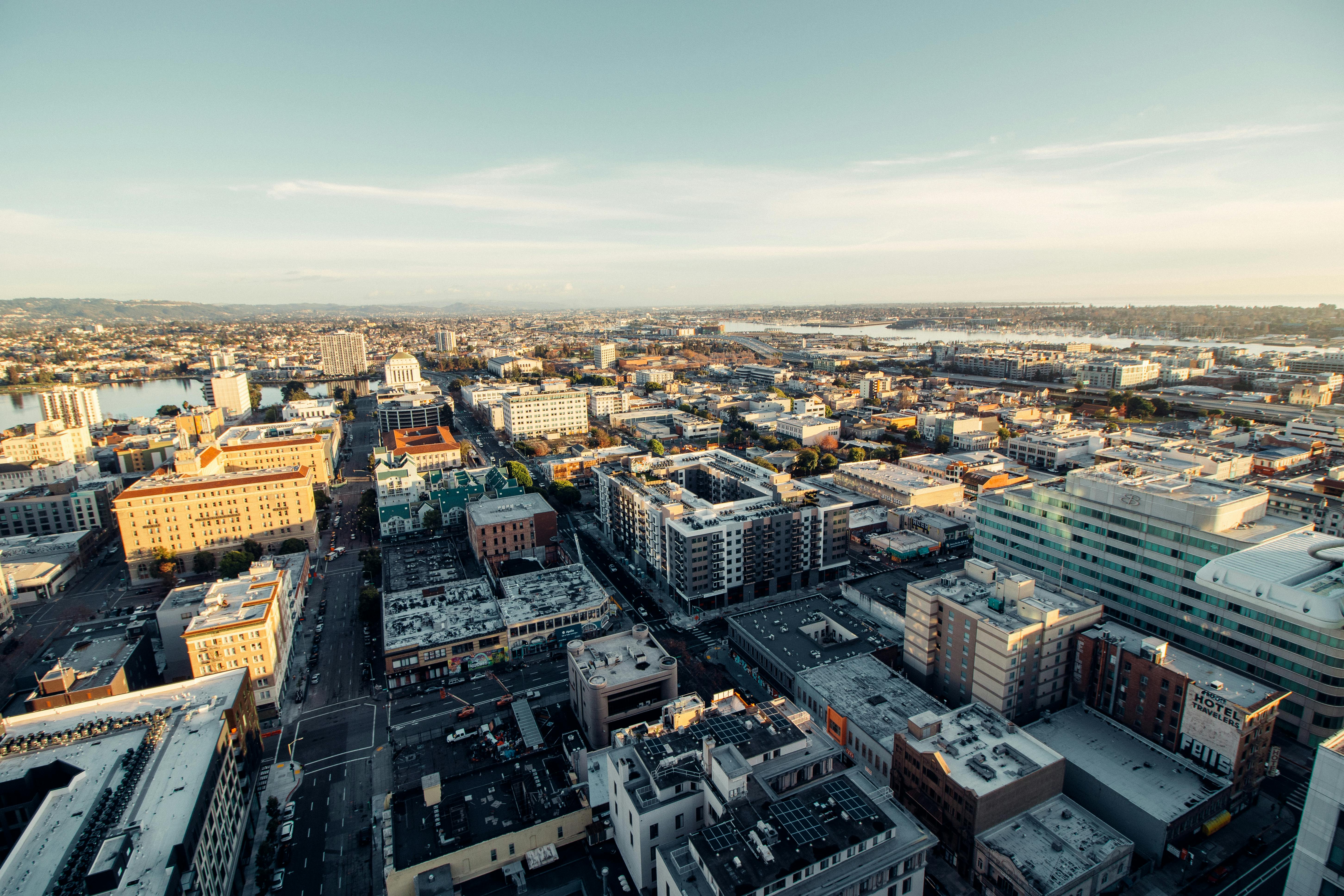 A breathtaking aerial view showcasing a sprawling urban cityscape under a clear sky.