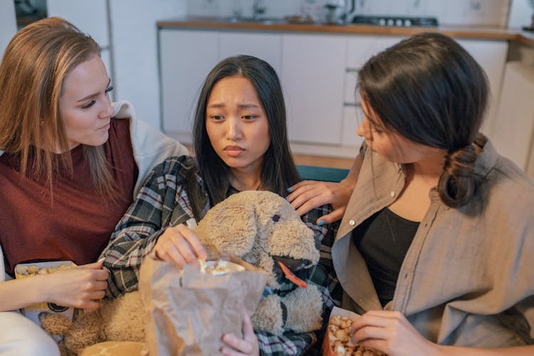 Woman In Plaid Shirt Holding Brown Animal Plush Toy