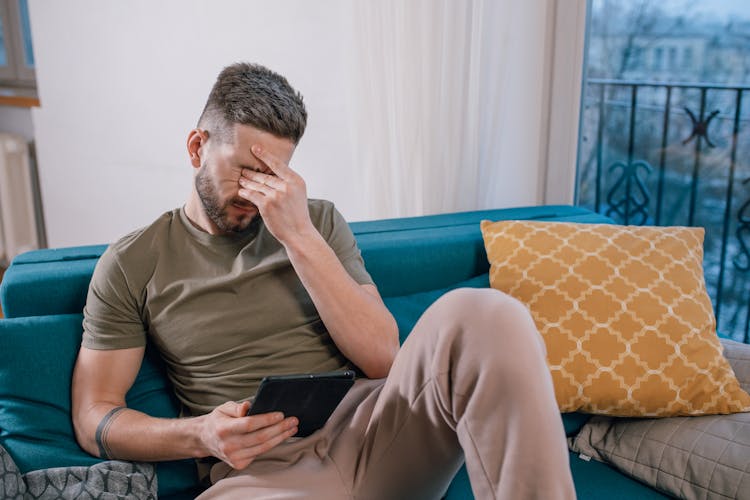 A Man With A Black Tablet Crying