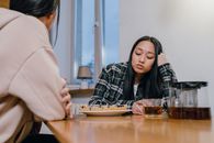 A Sad Woman in Black Plaid Long Sleeves