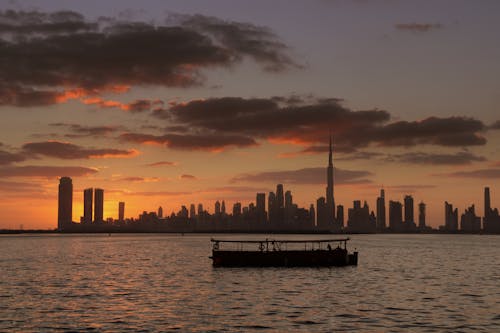 Silhouette of a Boat on the Sea during Sunset