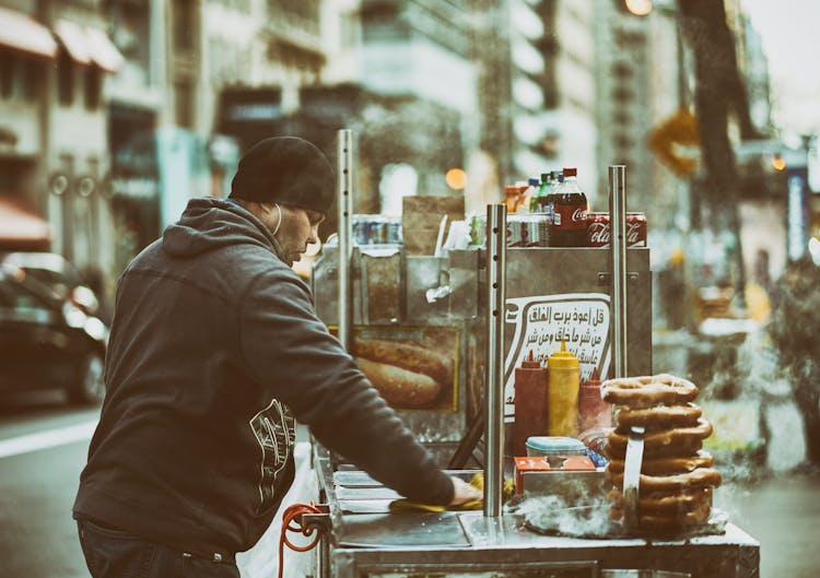 Man Cleaning His Street Food Cart