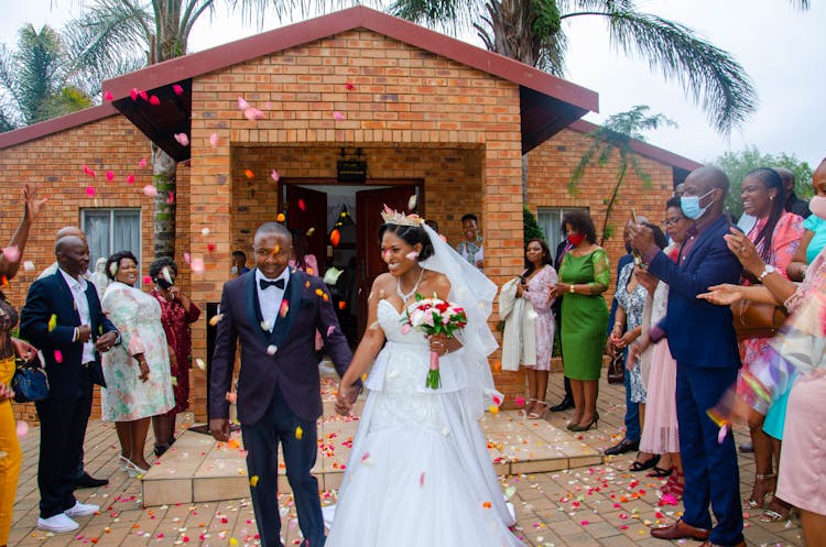 Happy Black Newlywed Couple At Wedding Among Guests