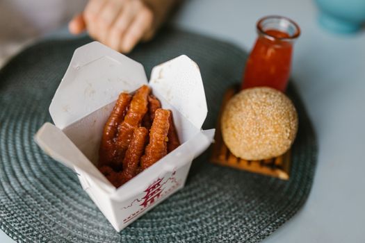Close-up of crispy Asian pastries and sesame balls in a stylish food setting.