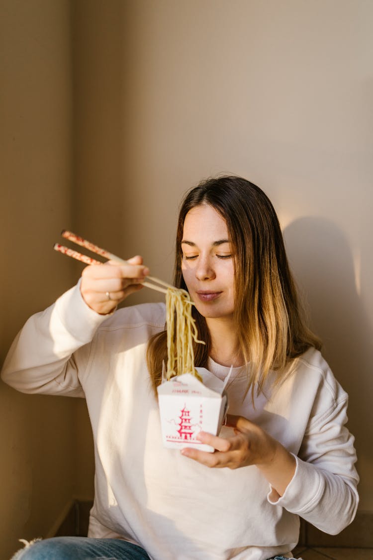 A Woman Eating Noodles