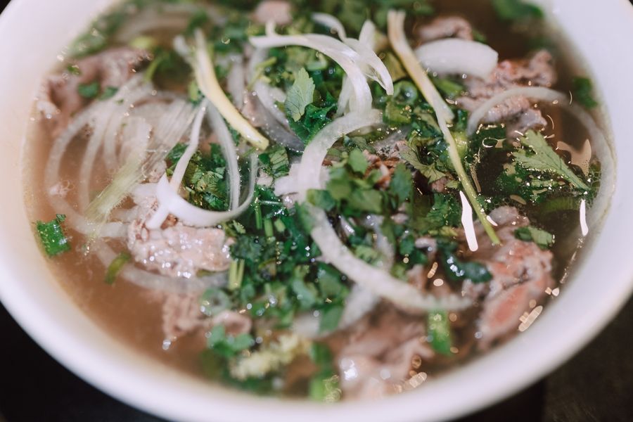 A hearty bowl topped with a soft egg and herbs