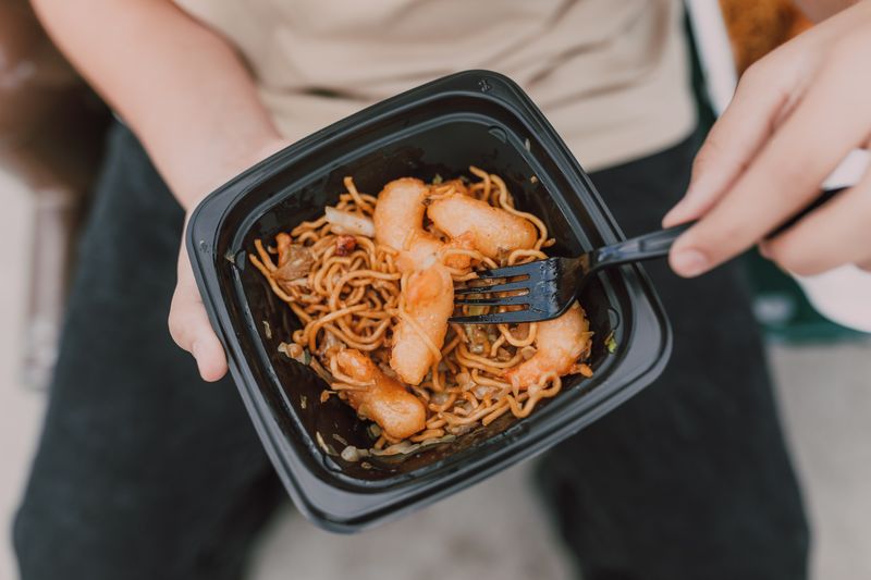 Hot noodles in a takeout container, eaten minutes after leaving the kitchen — photo by RDNE Stock project on Pexels