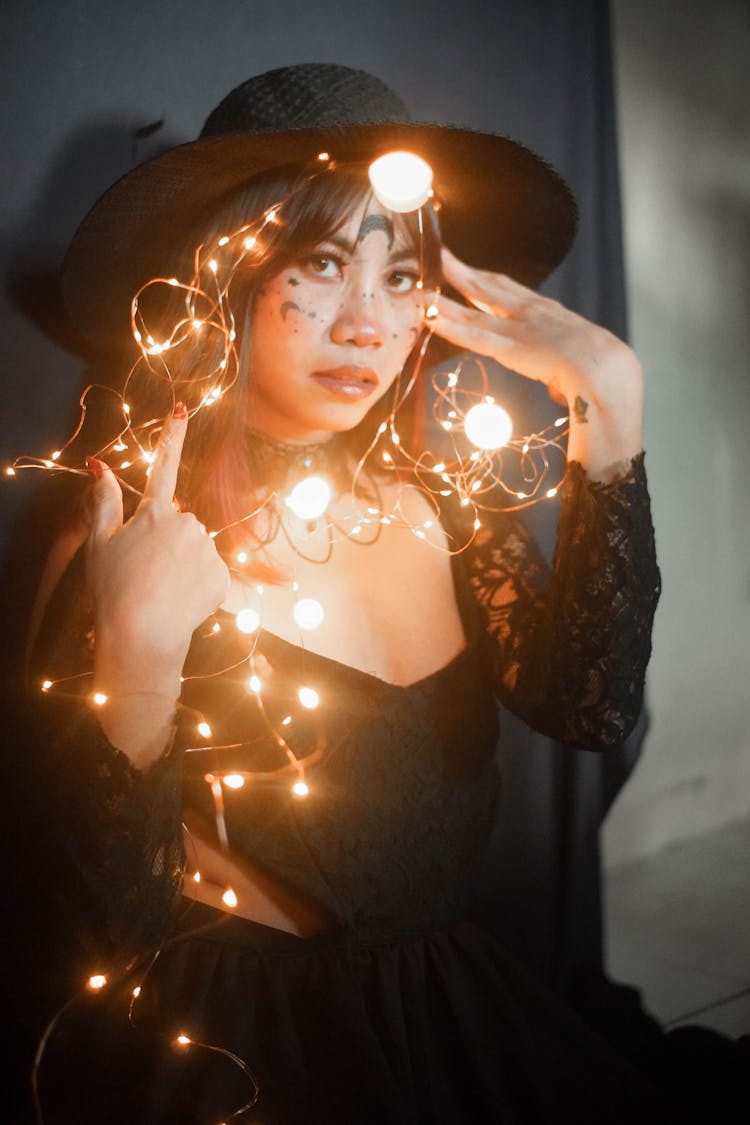 Woman Wearing Her Black Costume With Fairy Lights 